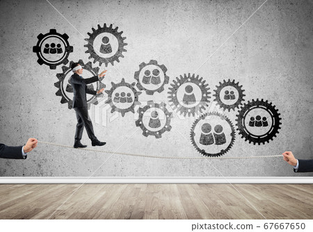 Business concept of risk support and assistance with man balancing on rope Business concept of risk support and assistance with man balancing on rope 67667650
