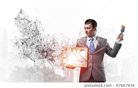 Creative businessman painter holding paintbrush 67667656