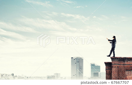 Danger and risk concept with businessman making step from edge 67667707