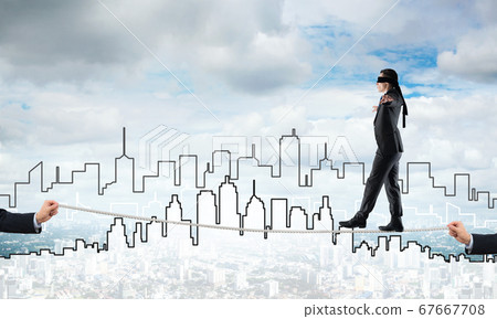 Business concept of risk support and assistance with man balancing on rope Business concept of risk support and assistance with man balancing on rope 67667708
