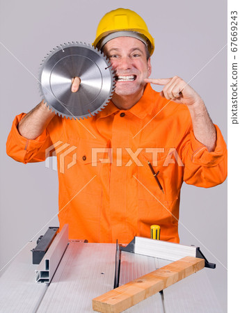 construction worker and circular saw 67669243