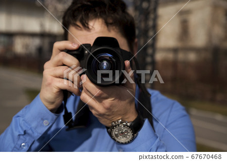 Photographer photographing outdoors. Shooting in 67670468
