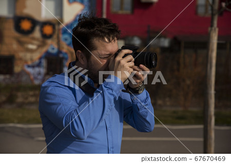 Photographer photographing outdoors. Shooting in Photographer photographing outdoors. Shooting in 67670469