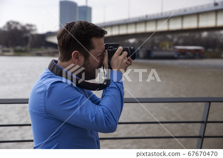 Photographer photographing outdoors. Shooting in Photographer photographing outdoors. Shooting in 67670470
