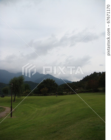 A man taking a photo in a spacious place 67671170