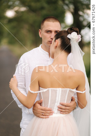 Portrait of groom and bride in their wedding day. Summer wedding 67671426