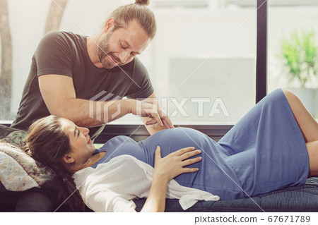 Pregnancy wife stay home with lovely husband cute playing with baby tummy 67671789