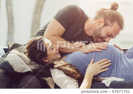 Good Husband and Pregnant wife with romantic moment love together kissing baby tummy  67671792