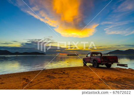 Old pickup truck parked on the waterfront with Old pickup truck parked on the waterfront with 67672022