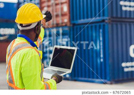 Computer laptop blank screen with back view of foreman staff worker working in logistic 67672065