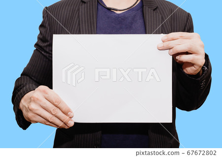 Closeup Business man hand holding show blank paper sheet mock up empty white board Closeup Business man hand holding show blank paper sheet mock up empty white board 67672802