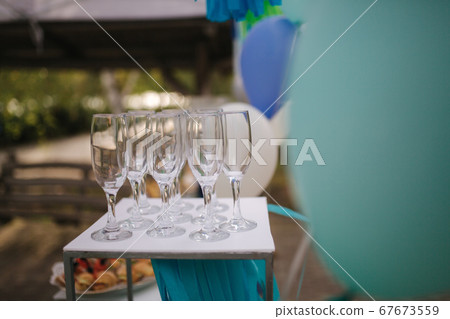 Glasses for champagne on terrace on the table. Party 67673559