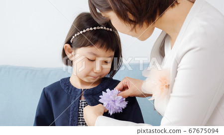 Family preparing for entrance ceremony 67675094