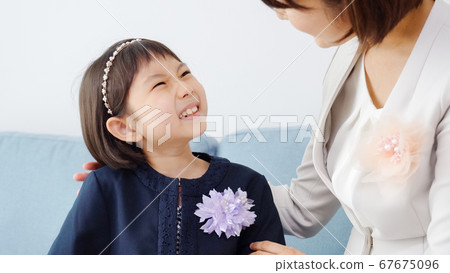 Family preparing for entrance ceremony Family preparing for entrance ceremony 67675096