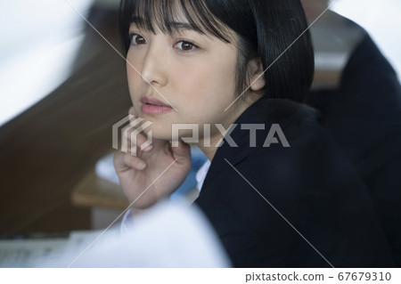 Students studying in a classroom 67679310