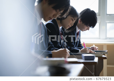 Students studying in a classroom 67679323