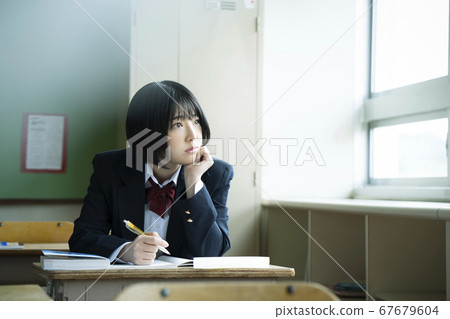 Students studying in a classroom 67679604