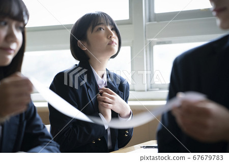 Students taking a test in the classroom 67679783