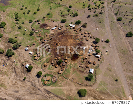 Aerial view of Maasai boma or family rural village on the coast of Salty lake Natron in the Great Rift Valley, Tanzania 67679837