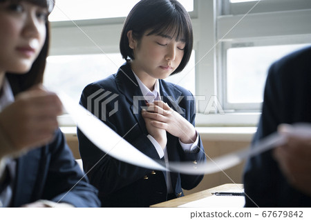 Students taking a test in the classroom Students taking a test in the classroom 67679842