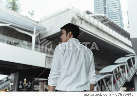 Man at sky train entrance. Man at sky train entrance. 67680445