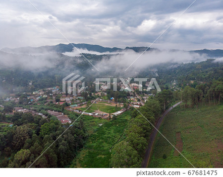 Aerial Drone Shot Flying by Cloudy Misty Foggy Lushoto village in Usambara Mountains. Remote Place in Tanga Province, Tanzania, Africa Aerial Drone Shot Flying by Cloudy Misty Foggy Lushoto village in Usambara Mountains. Remote Place in Tanga Province, Tanzania, Africa 67681475