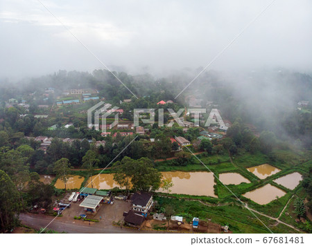 Aerial Drone Shot Flying by Cloudy Misty Foggy Lushoto village in Usambara Mountains. Remote Place in Tanga Province, Tanzania, Africa Aerial Drone Shot Flying by Cloudy Misty Foggy Lushoto village in Usambara Mountains. Remote Place in Tanga Province, Tanzania, Africa 67681481