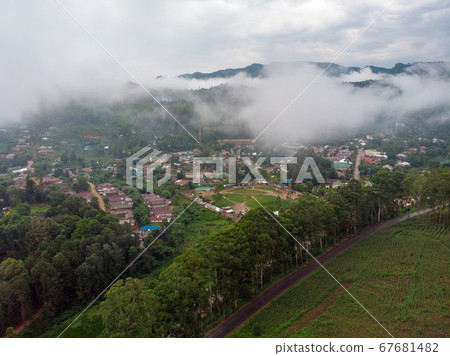 Aerial Drone Shot Flying by Cloudy Misty Foggy Lushoto village in Usambara Mountains. Remote Place in Tanga Province, Tanzania, Africa Aerial Drone Shot Flying by Cloudy Misty Foggy Lushoto village in Usambara Mountains. Remote Place in Tanga Province, Tanzania, Africa 67681482