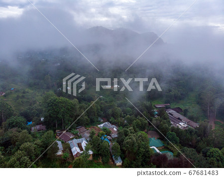 Aerial Drone Shot Flying by Cloudy Misty Foggy Lushoto village in Usambara Mountains. Remote Place in Tanga Province, Tanzania, Africa 67681483