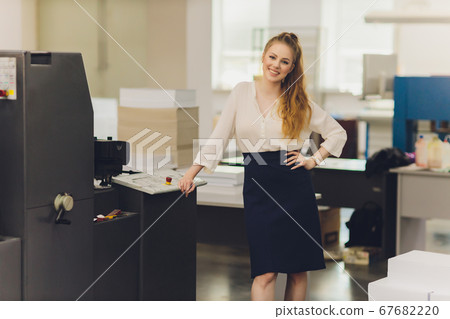 Young woman working in printing factory. Printing Press. 67682220
