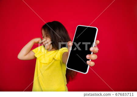 Beautiful emotional little girl isolated on red background. Half-lenght portrait of happy child gesturing Beautiful emotional little girl isolated on red background. Half-lenght portrait of happy child gesturing 67683711