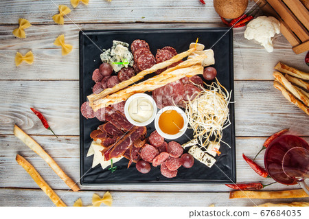 Wine appetizer set smoked sausages cheese honey Wine appetizer set smoked sausages cheese honey 67684035
