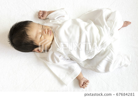 18 day old baby taking a nap 67684281