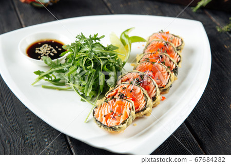Deep-fried salmon rolls with arugula and soy sauce Deep-fried salmon rolls with arugula and soy sauce 67684282