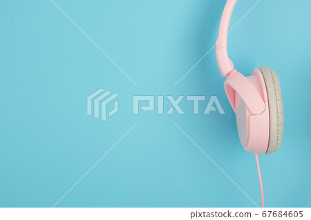 Pink headphones on blue background. Podcast, music, audiobook concept in minimal pop color style 67684605