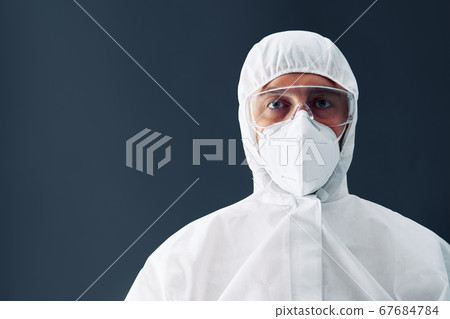 Doctor in protective medical suit with copy space on black background 67684784