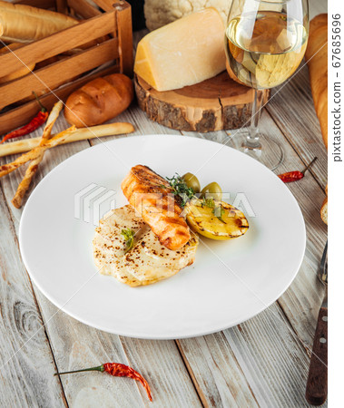 Gourmet dish grilled salmon steak potato gratin Gourmet dish grilled salmon steak potato gratin 67685696