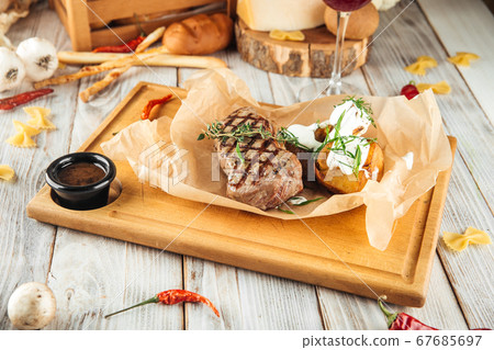 New yourk beef steak baked potatoes  sour cream 67685697