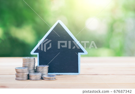 House placed on the table silver coins placed a House placed on the table silver coins placed a 67687342