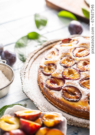 Homemade plum cake in vintage plate on wooden Homemade plum cake in vintage plate on wooden 67687546