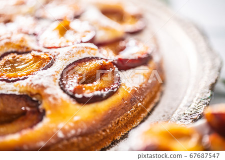 Homemade plum cake in vintage plate on wooden Homemade plum cake in vintage plate on wooden 67687547