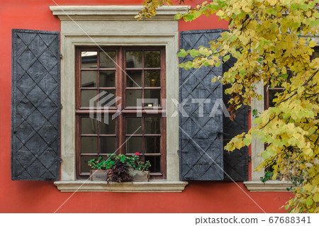 A large window with metal shutters 67688341
