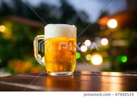 Beer foam outside with blurry lights background 67688528