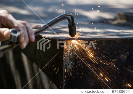 Worker cuts and brews black metal close-up shot 67688604