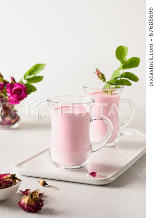Rose moon milk in glasses on white background. Rose moon milk in glasses on white background. 67688606