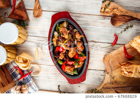 Chicken in cast-iron pan with vegetables Chicken in cast-iron pan with vegetables 67688829