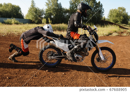 Pushing motorbike to launch it 67688905