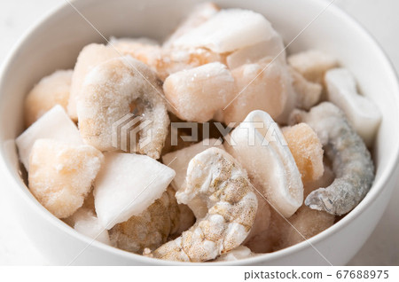 frozen seafood in white bowl 67688975