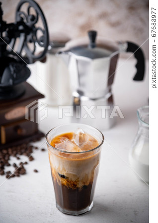 iced coffee with milk and dripping tools 67688977