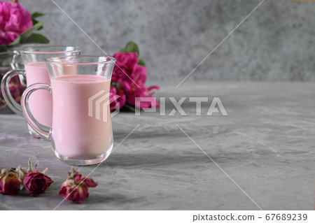 Rose moon milk and dry roses on grey. Copy space. 67689239